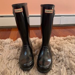 Black tall glossy hunter boots